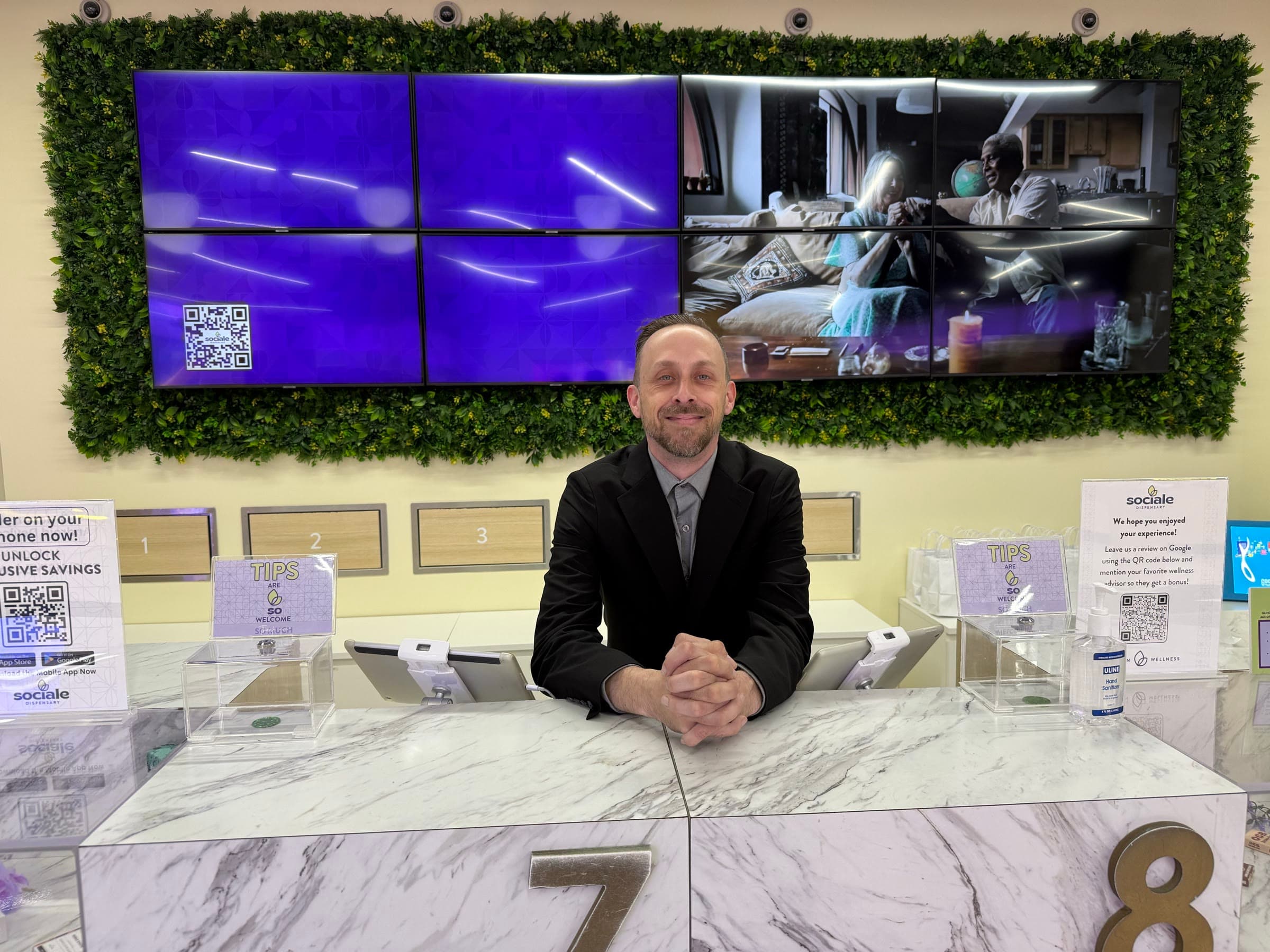 John Hirsch at a dispensary counter